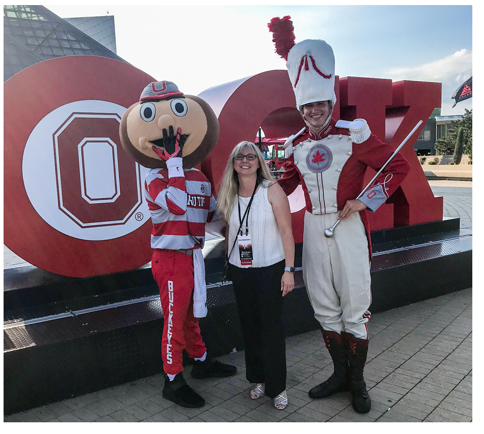 Donna with Brutus Buckeye and a member of the marching band.