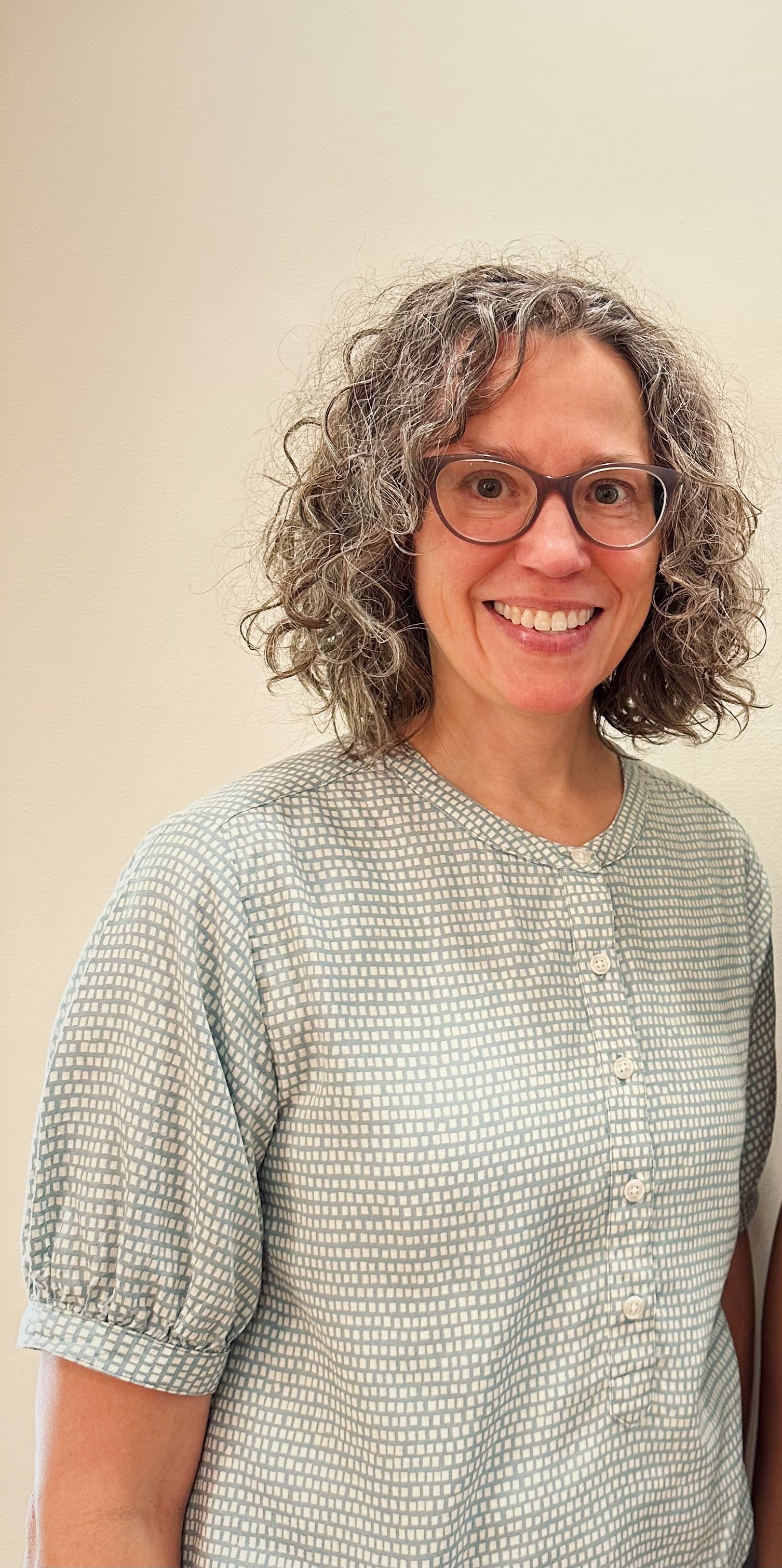 Headshot of Mary Thomas wearing a blouse.