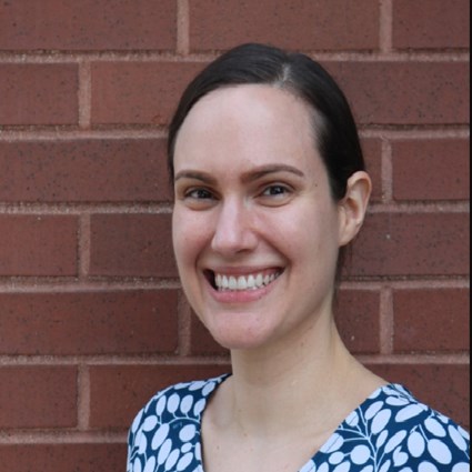 A headshot of Lauren Hensley with a blue and white patterned blouse