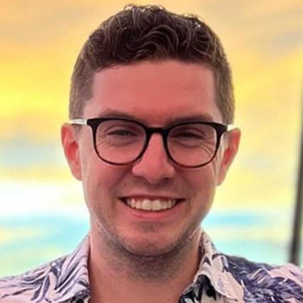 Headshot of Nathan Johnson wearing a blue and white shirt.