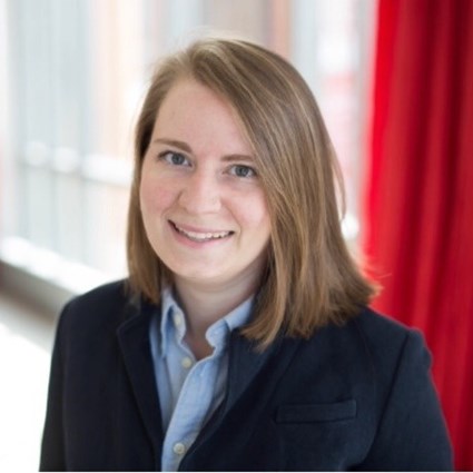 A headshot of Kaity Prieto with short straight hair wearing business attire