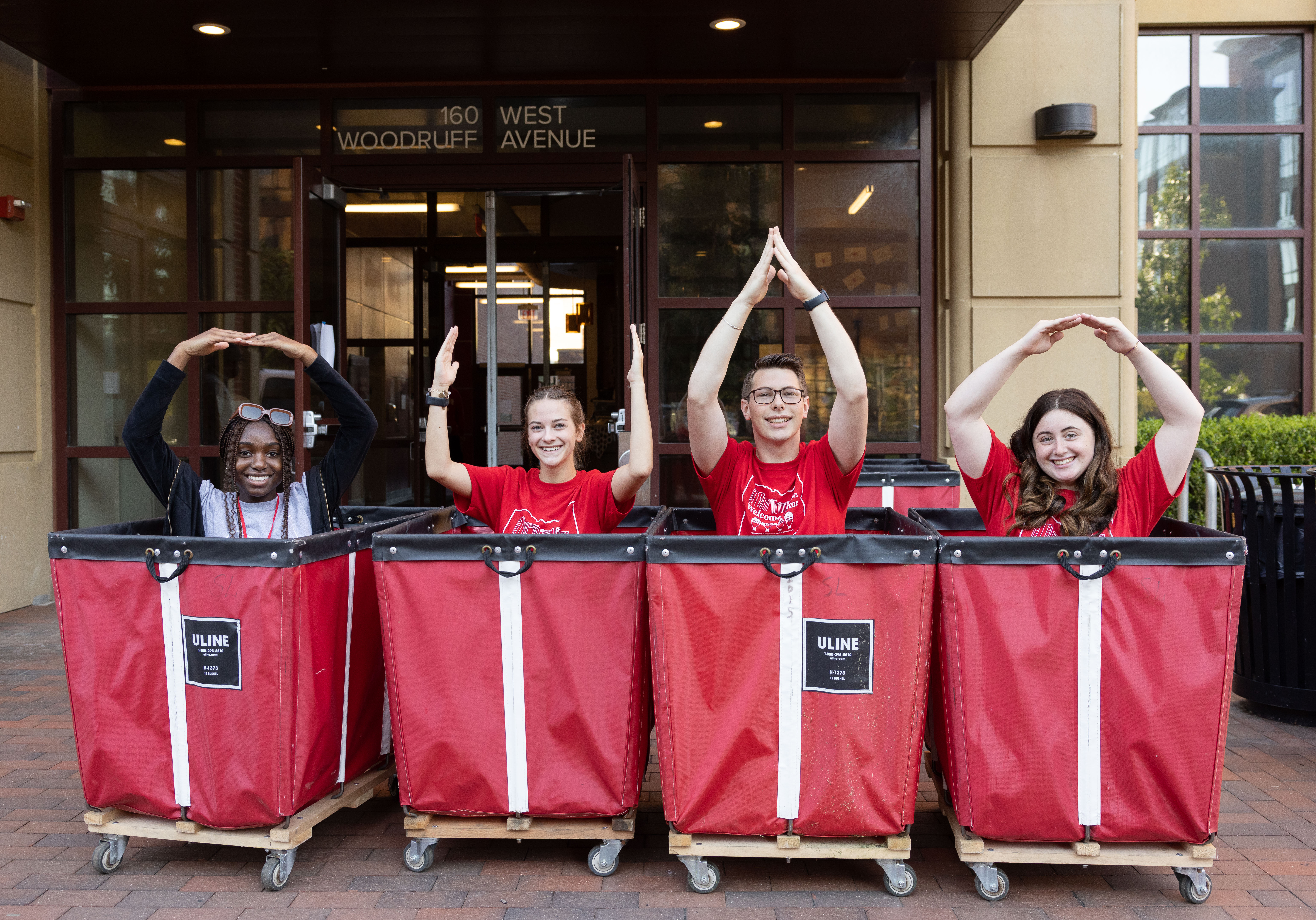 OWLS help students and parents during move in by helping with parking and providing red bins.