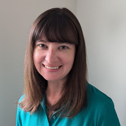 Headshot of Brianne Herrera wearing a teal shirt.