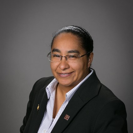 Headshot of Cherish Vance wearing a stripped button down shirt and black suit jacket.
